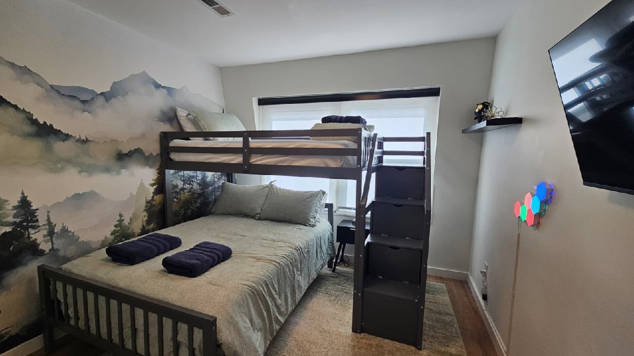 Mountain Bunkhouse bunk bedroom with mountain mural and LED hex lights